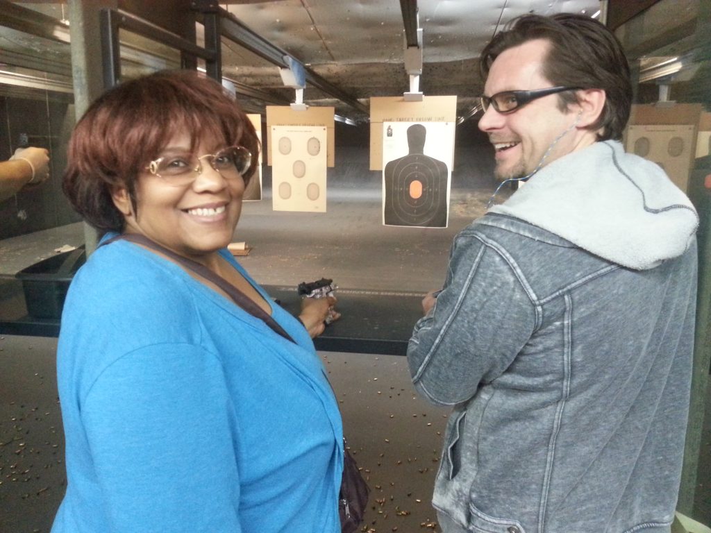 Two students on the firing line at an indoor range during a Michigan CPL class